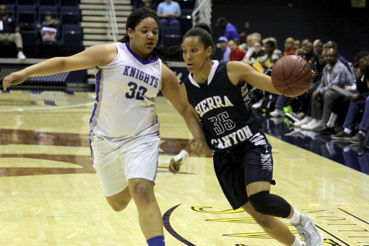 Sierra Canyon's Alexis Griggsby (right) drives past Brookside Christian's Zhane Lewis in Saturday's CIF Division IV state final at Haas Pavilion.
