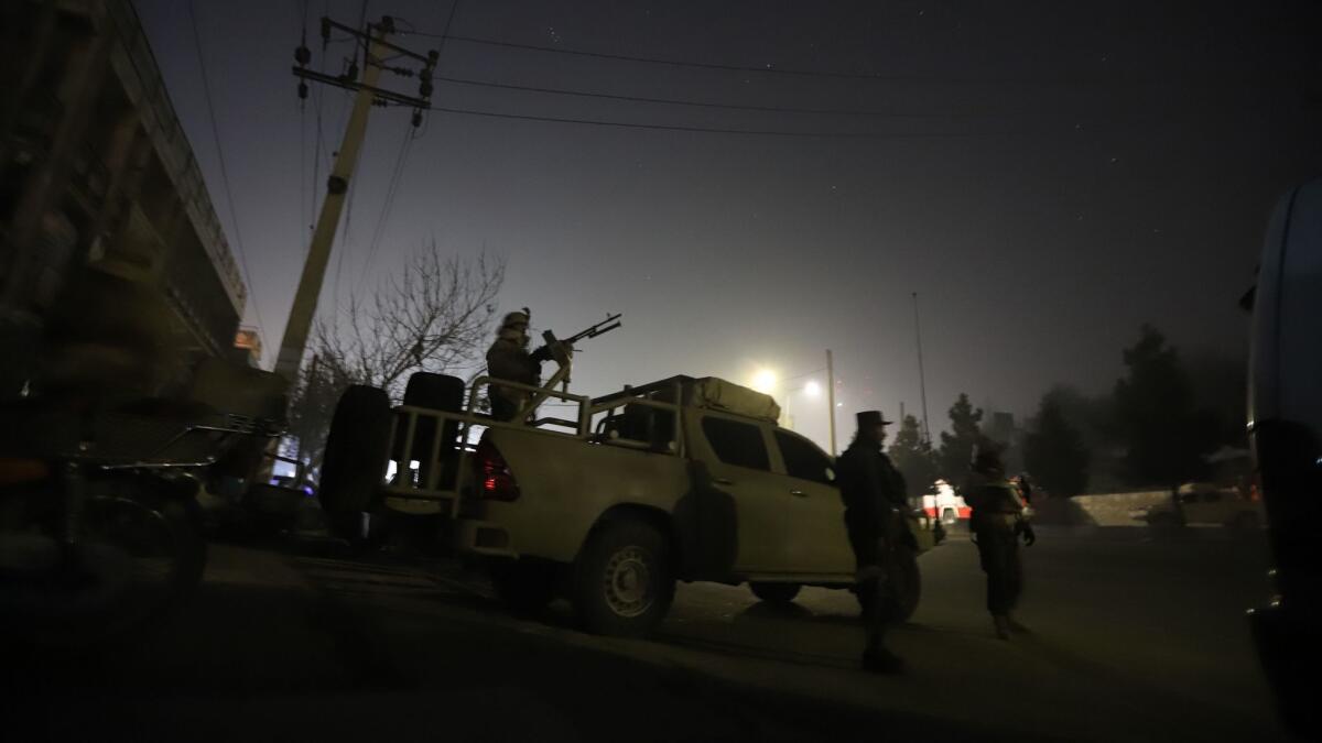 Afghan security forces take up positions near Kabul's Intercontinental Hotel, where a group of armed men staged an attack on Saturday.