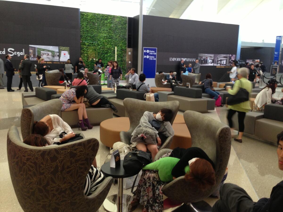 Passengers relax at the Tom Bradley International Terminal at Los Angeles International Airport.