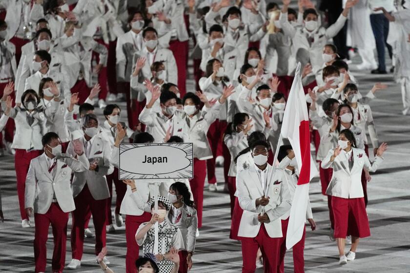 Yui Susaki and Rui Hachimura, of Japan, carry their country's flag during the opening ceremony in the Olympic Stadium at the 2020 Summer Olympics, Friday, July 23, 2021, in Tokyo, Japan. (AP Photo/David J. Phillip)