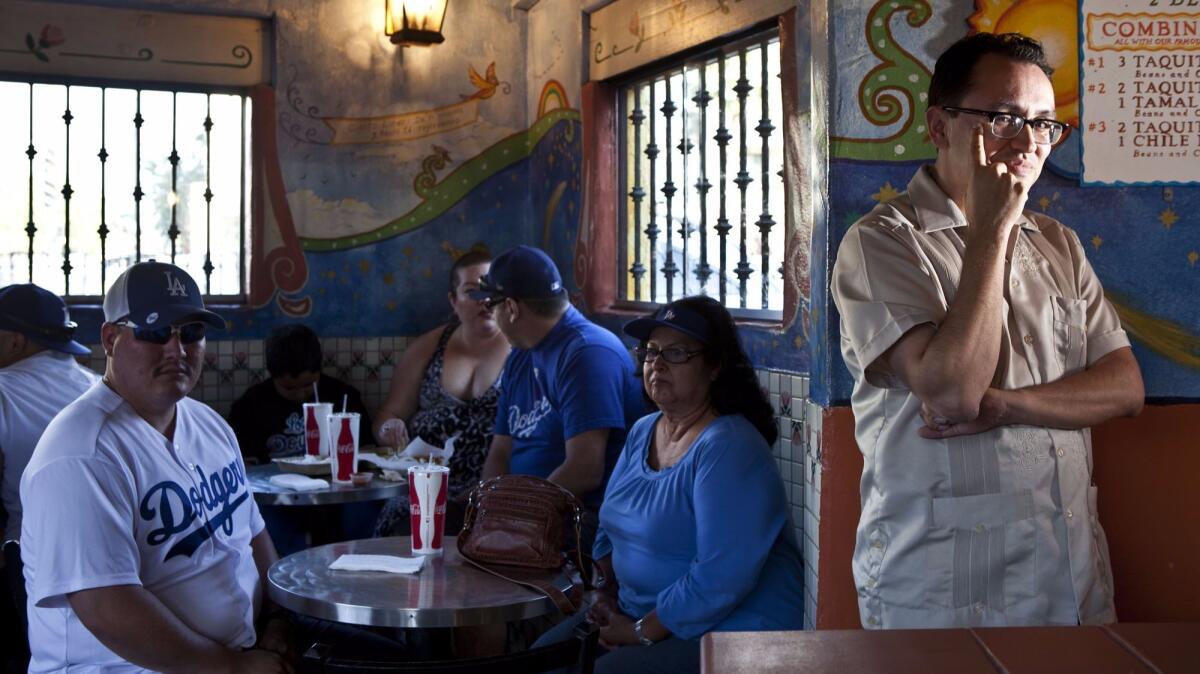 Gustavo Arellano poses at the Cielito Lindo restaurant in downtown Los Angeles in 2012.