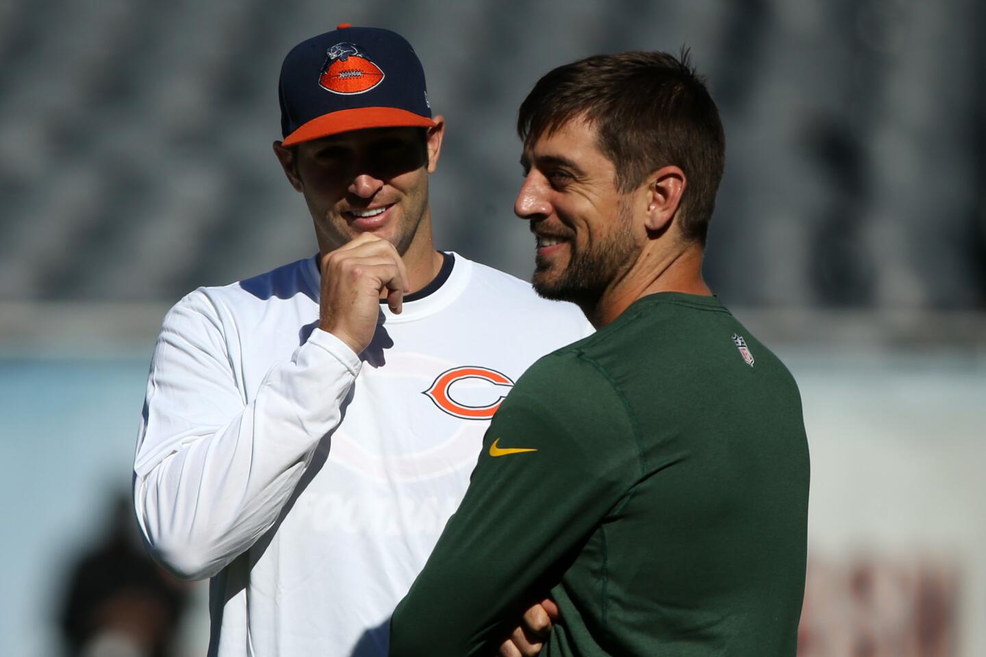 Packers quarterback Aaron Rodgers chats with Jay Cutler prior to their game.