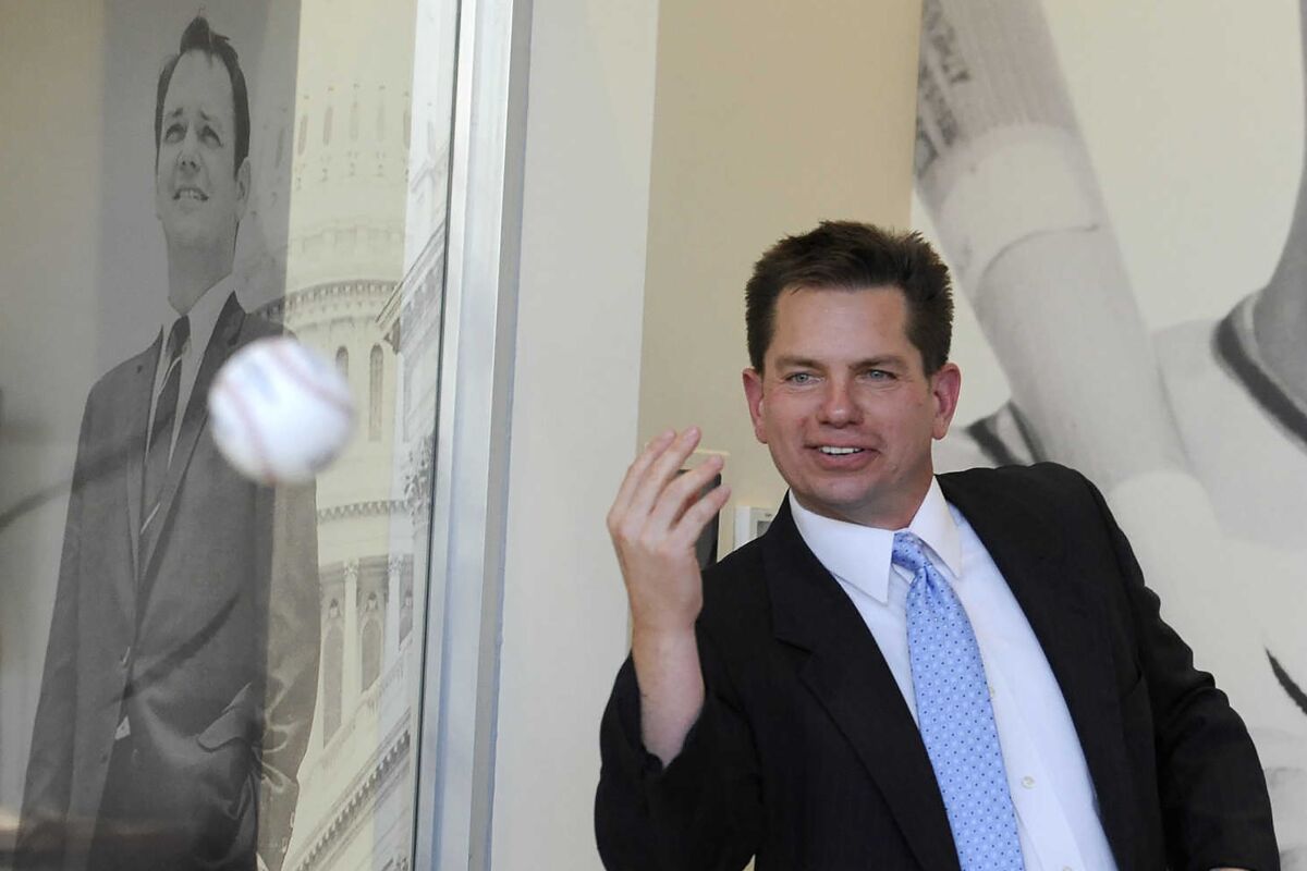 Rex Rust, co-president of Rust Communications, tosses a baseball to his brother, Gary II, during the dedication and open house of Southeast Missouri State University's new Rust Center for Media on Oct. 7, 2016, in Cape Girardeau, Mo. Rust, co-president of the Missouri-based media company Rust Communications, has died Thursday evening, Jan. 6, 2022, after a yearlong battle with cancer. He was 52. (The Southeast Missourian via AP)