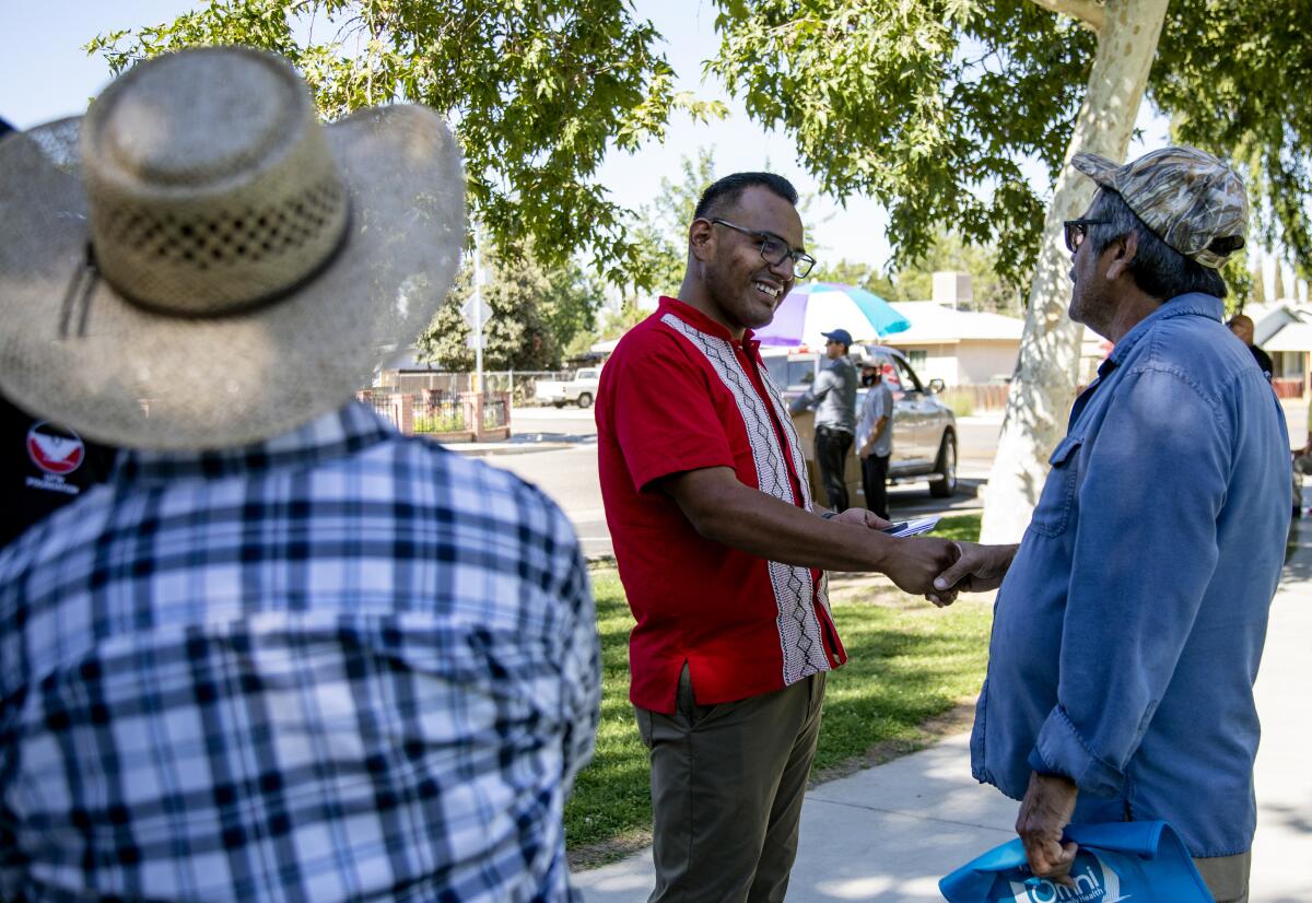 Two people shake hands