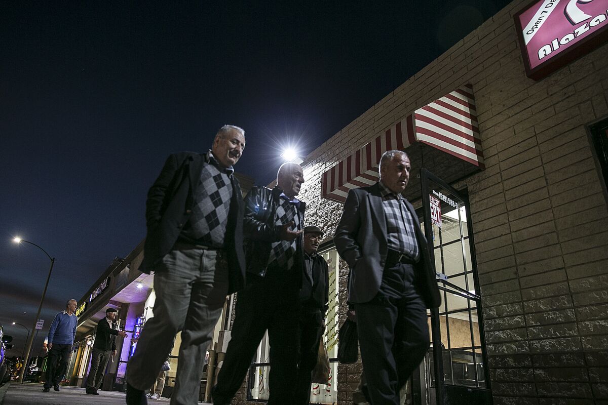 Men walk together along Main Street in El Cajon, home to numerous Iraqi owned businesses.