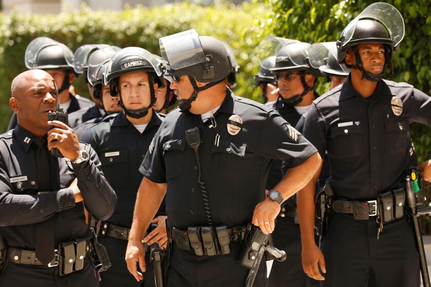 LAPD officers at a protest near City Hall on Tuesday, July 12.