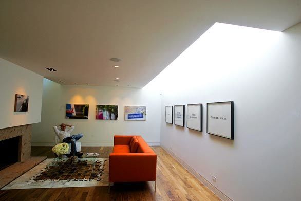 Simple planes and the dramatic play of light define the den.