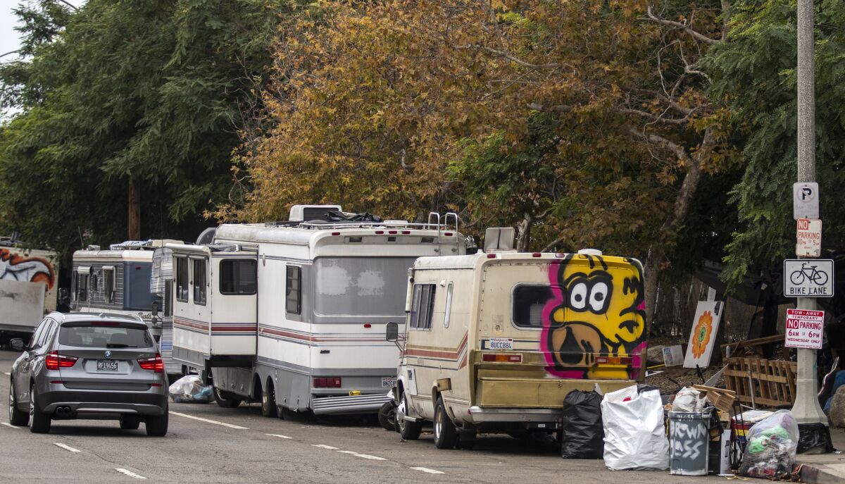 A row of parked RVs abuts an encampment for unhoused residents in Venice on Nov. 1.