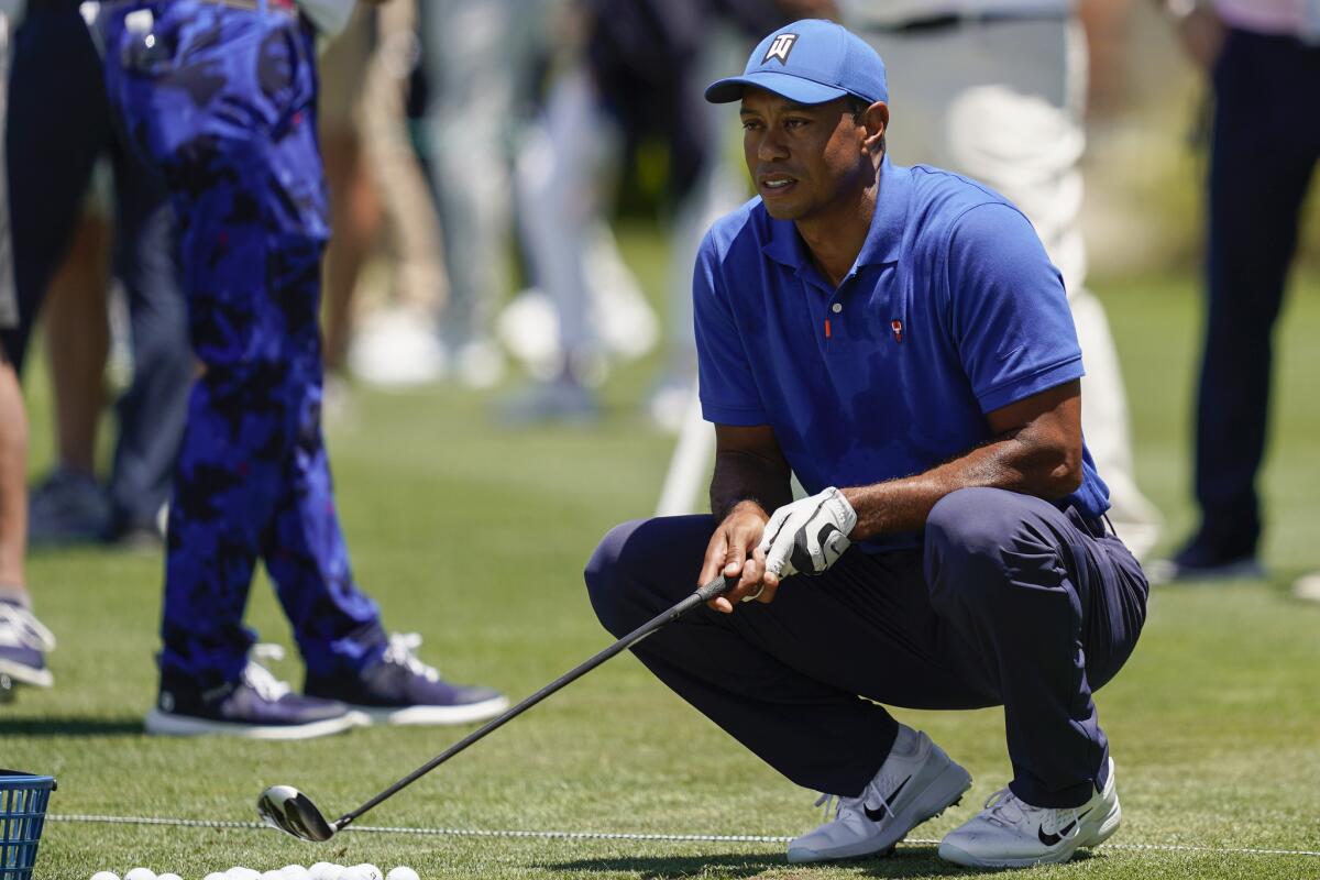 Tiger Woods crouches at the driving range during a practice day for the U.S. Open on Tuesday, June 11, 2019, in Pebble Beach, Calif. (AP Photo/David J. Phillip)