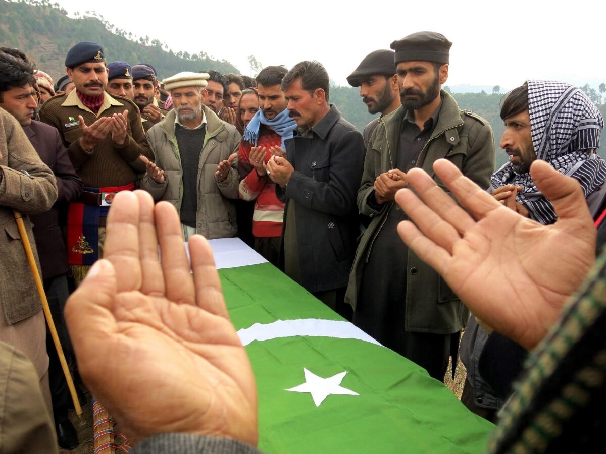 Pakistani army officials and relatives attend the funeral of a Pakistani soldier killed in a bomb blast that targeted a paramilitary convoy.