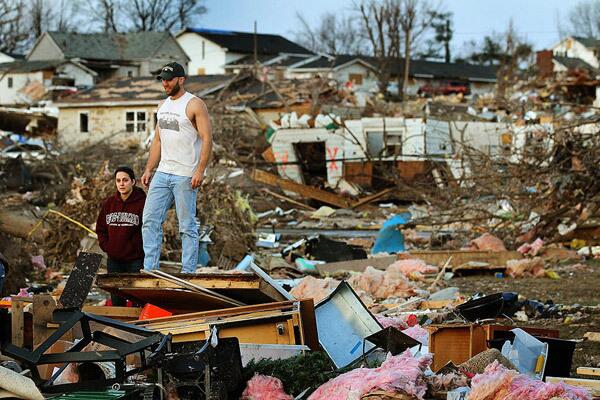 Josh Summers and his wife Lindsey search for their possessions after a tornado ripped through their neighborhood.