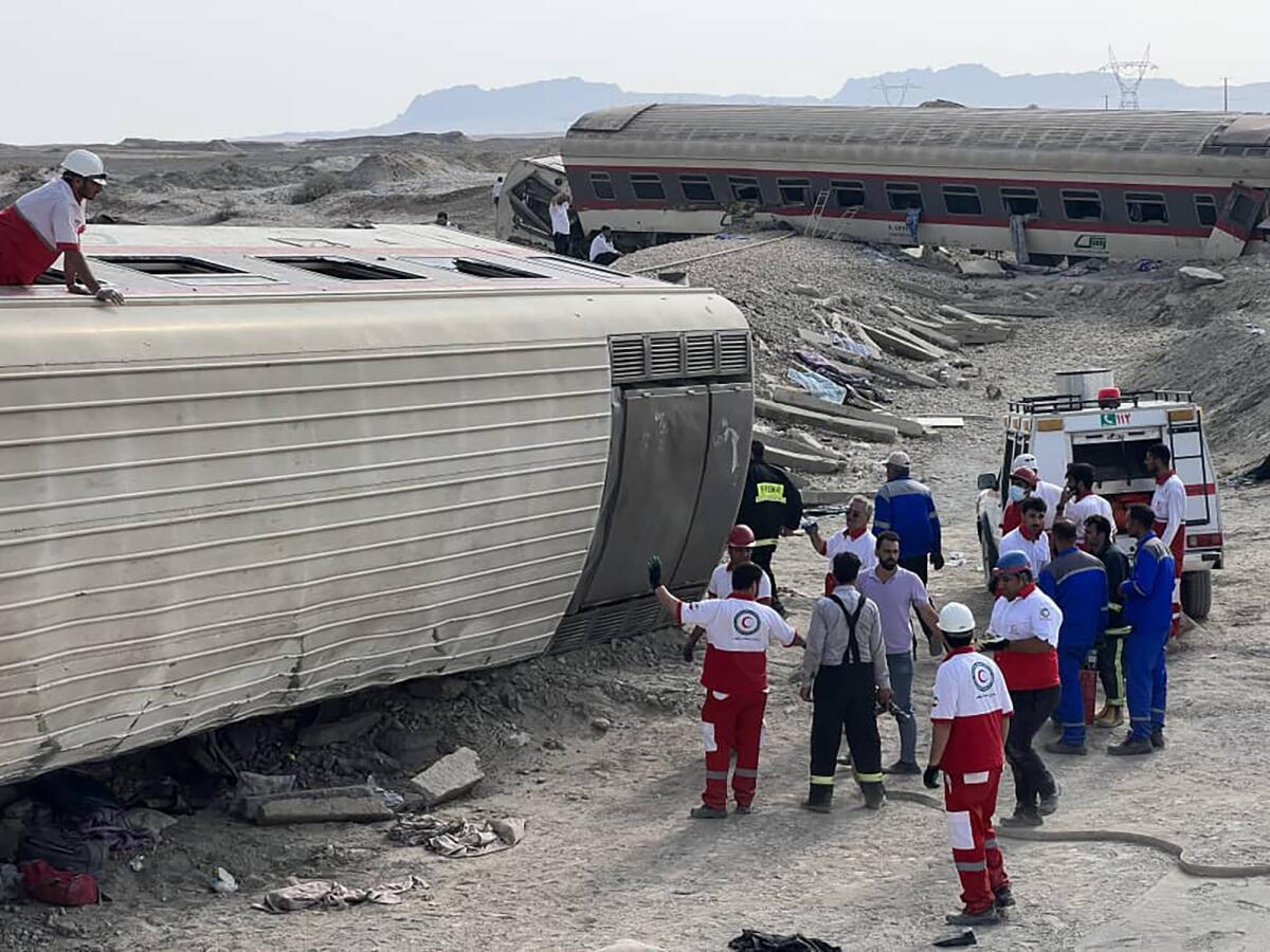 Rescue workers next to derailed train
