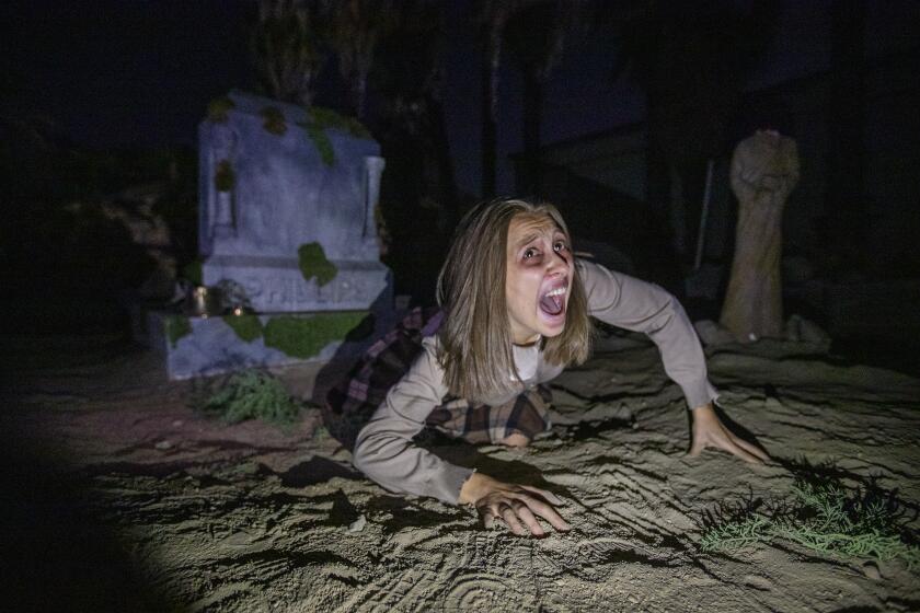 Pomona, CA - October 10: Gabie Faulkner is "Lily" in the graveyard at the Haunted House Delusion shows how the immersive entertainment movement has grown. This is a shoot of parts of the actual experience at Phillips Mansion on Sunday, Oct. 10, 2021 in Pomona, CA. (Allen J. Schaben / Los Angeles Times)