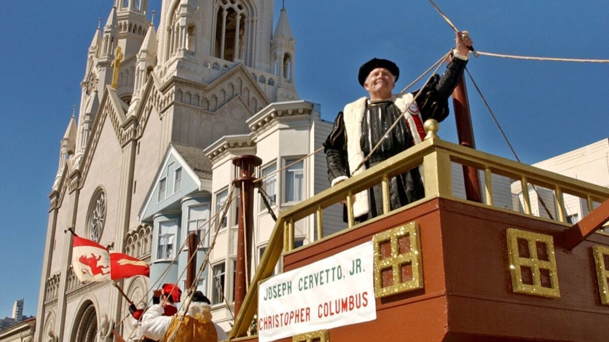 Joseph Cervetto Jr. holds up a sword while dressed as Christopher Columbus on a float during San Francisco's Italian Heritage Parade in 2003.
