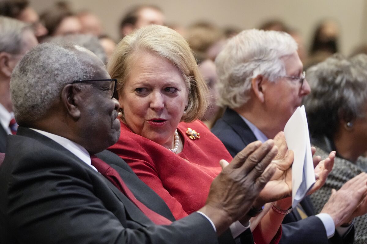 Associate Supreme Court Justice Clarence Thomas sits with his wife and conservative activist Virginia Thomas