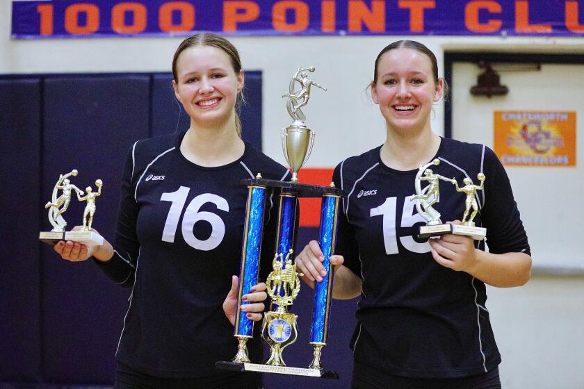 Thousand Oaks sisters London, left, and Saylor Halvorsen hold the championship trophy and all-tournament awards