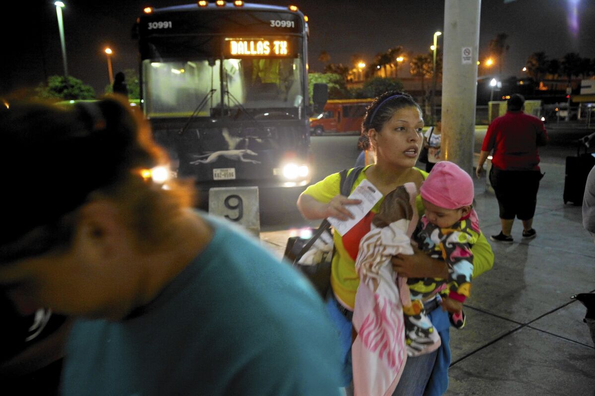 Larisa Lara of Honduras holds her 6-month-old daughter, Annie, as she boards a bus in McAllen, Texas. She spent 10 days crossing Mexico and was planning to join her father in Dallas. Many of the recent migrants are young women with children fleeing unrest back home.