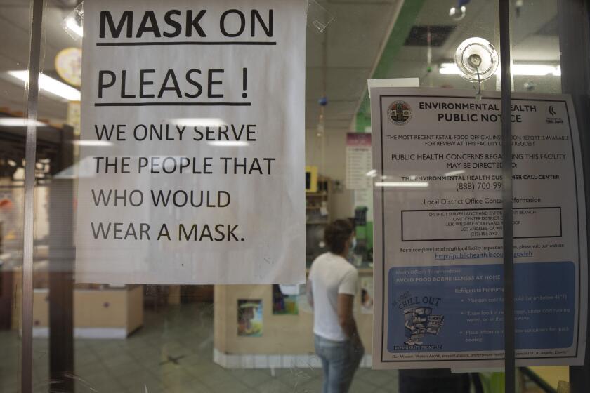 LOS ANGELES, CA - JULY 17: A sign at a Chinatown business reminds customers to wear a mask. The LA County mask mandate will go into effect at 11:59 p.m. Saturday, July 17, 2021 requiring masks be worn indoors with the exception that masks can be removed if dining in a restaurant. Photographed in Chinatown on Saturday, July 17, 2021 in Los Angeles, CA. (Myung J. Chun / Los Angeles Times)