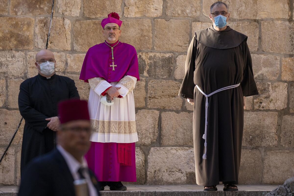 Archbishop Pierbattista Pizzaballa arrives at the Church of the Holy Sepulcher, the place where Christians believe Jesus Christ was buried, in Jerusalem's old city Thursday.