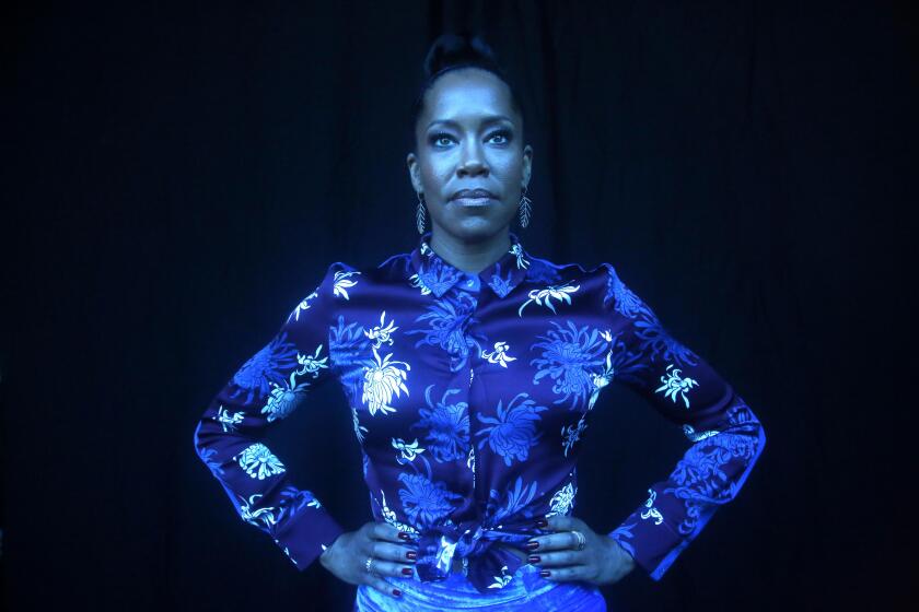 BEVERLY HILLS, CA - OCTOBER 15, 2019 - - Academy-Award winning actress Regina King strikes a hero’s pose for her new role in HBO's adapation of, "Watchmen.” The series stars King as Angela Abar, who is also the mysterious masked Sister Night. She was photographed in Beverly Hills on October 15, 2019. (Genaro Molina / Los Angeles Times) FYI EDITOR: THIS IS A TRIPLE EXPOSURE GELLED FOR BLUE. THINK CAPTAIN MANHATTAN FROM THE WATCHMEN SERIES.