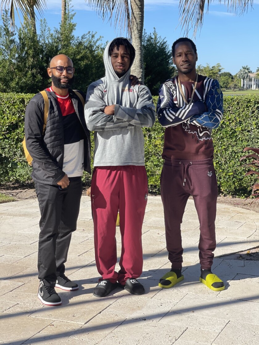 Uncle Terrell Samuel, left, with Asante Samuel Jr., center, and Asante Sr.