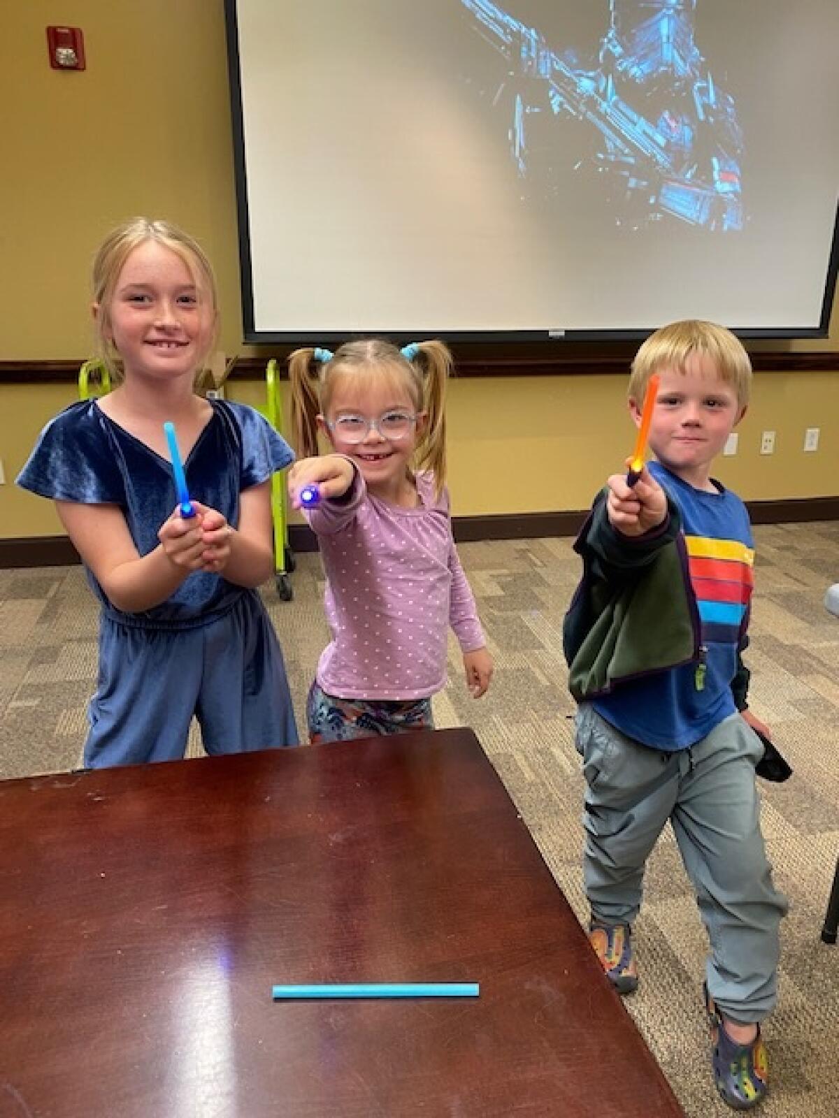 Children made mini LED light sabers at a Star Wars Day "May the Fourth Be With You"-inspired STEAM Tuesday workshop.
