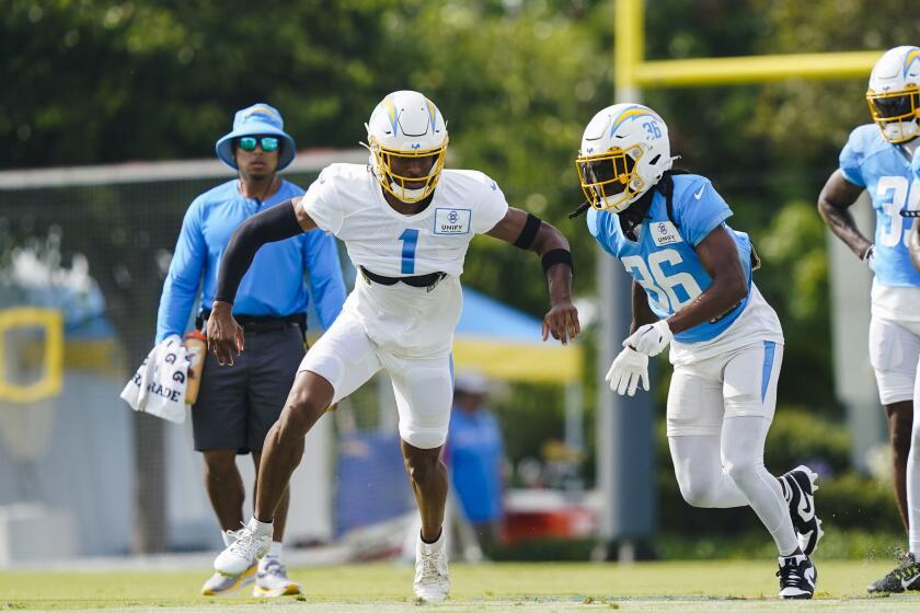 Chargers receiver Quentin Johnston and cornerback Ja'Sir Taylor participate in drills 