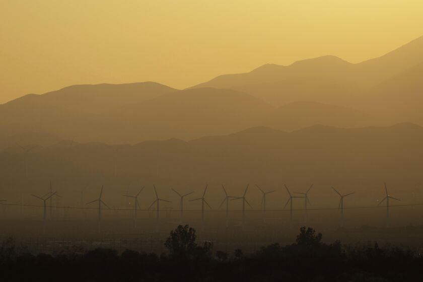 DESERT HOT SPRINGS, CA - JULY 28, 2021 - - The sun sets over windmills on a day where temperatures reach a high of a 110 in Desert Hot Springs on July 28, 2021. (Genaro Molina / Los Angeles Times)