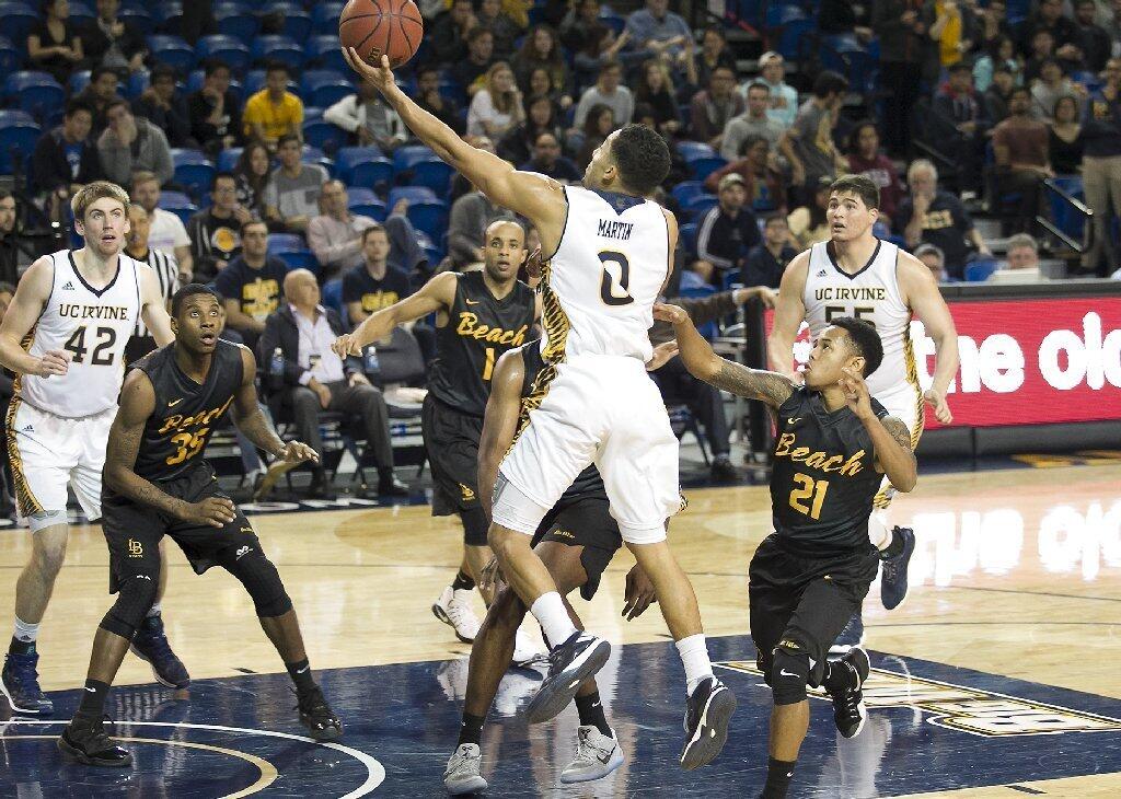 UC Irvine's Jaron Martin runs around the defense and lays it up and in against Long Beach State.