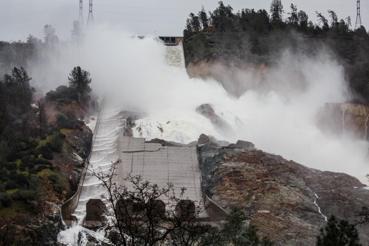Water escapes a badly damaged concrete spillway at Oroville Dam.