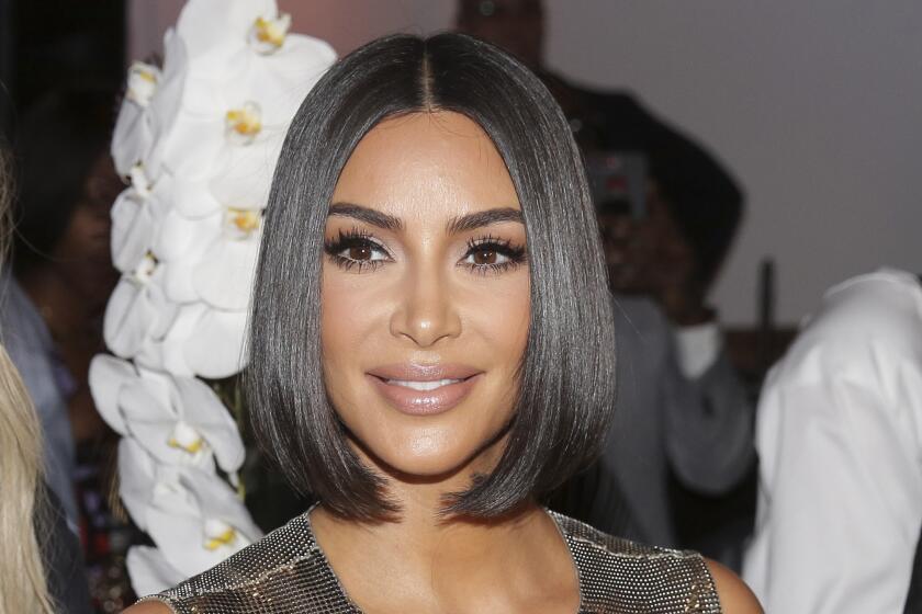 FILE - Kim Kardashian arrives to the Serena Williams fashion show during Fashion Week in New York, Sept. 10, 2019. French authorities on Friday, Nov. 19, 2021 say 12 people will stand trial in Paris over a $10 million jewelry heist targeting Kim Kardashian West in 2016. The reality TV star said she was tied up at gunpoint and locked in a bathroom after armed robbers forced their way into her rented Paris apartment during fashion week. (AP Photo/Seth Wenig, File)