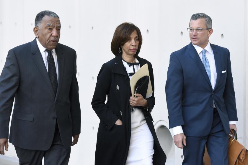 Former Baltimore mayor Catherine Pugh, center, and her attorney Steven Silverman, right, arrive for a sentencing hearing at U.S. District Court in Baltimore on Thursday, Feb. 27, 2020. Pugh pleaded guilty in 2019 to federal conspiracy and tax evasion charges. (AP Photo/Steve Ruark)