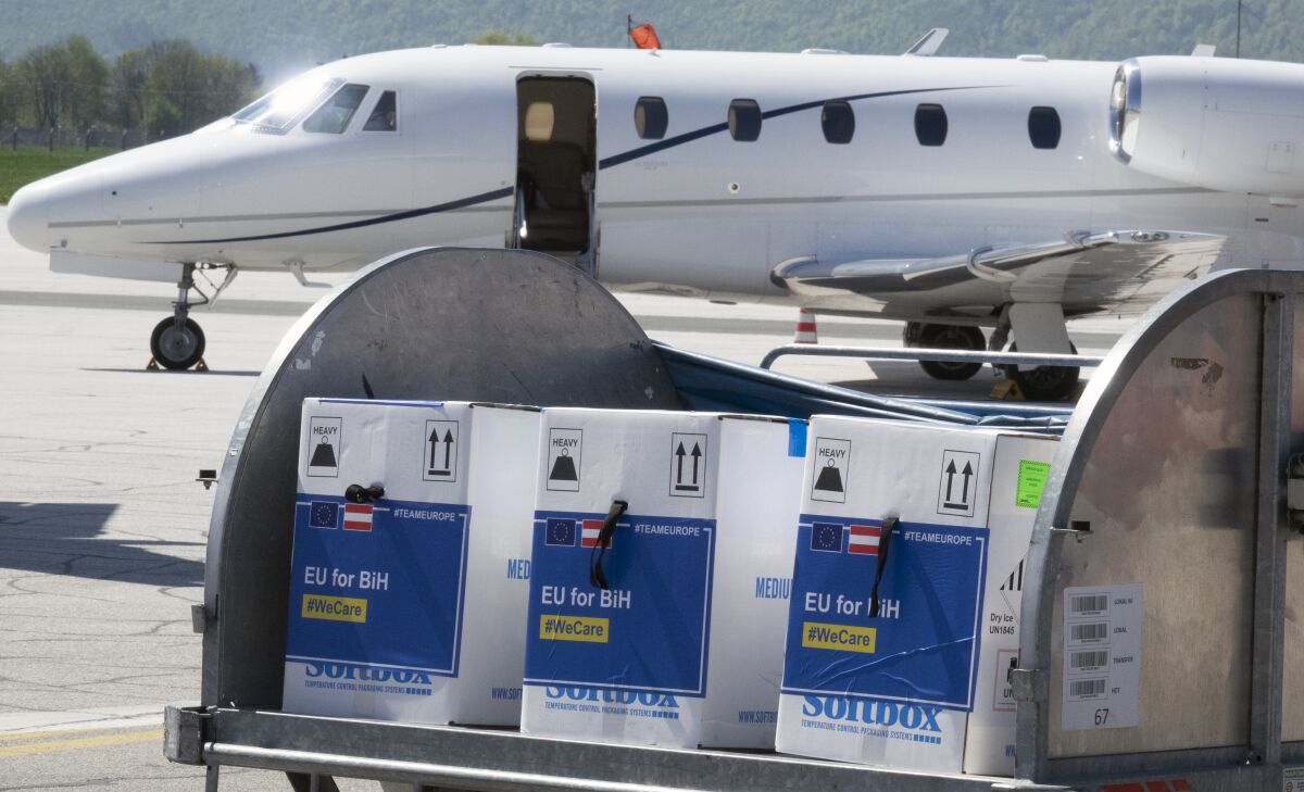 A container with boxes of the Pfizer vaccine delivered, at the Sarajevo Airport, Bosnia, Tuesday, May 4, 2021. The European Union has started delivering EU-funded coronavirus vaccines across the Balkans, where China and Russia have for months been supplying the much-needed shots and thus making political gains. (AP Photo/Eldar Emric)