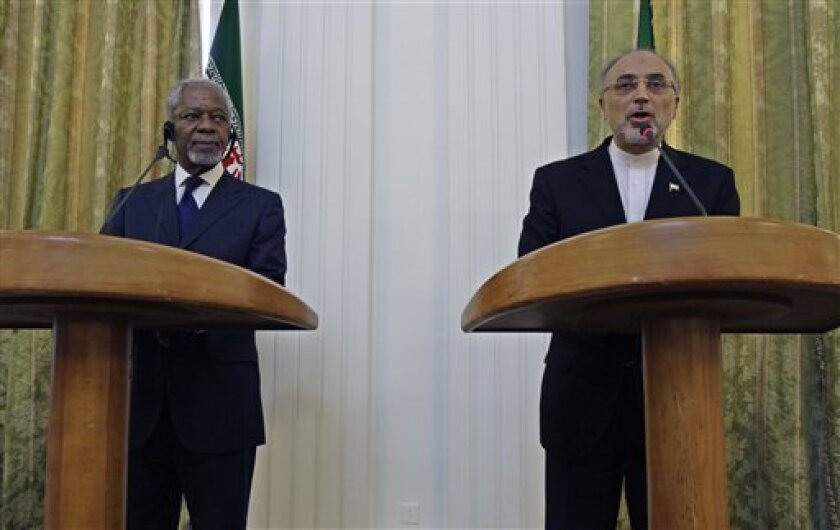 Iranian Foreign Minister Ali Akbar Salehi, right, speaks with media during a joint press conference with International envoy Kofi Annan, left, after their meeting in Tehran, Iran, Tuesday, July 10, 2012. Annan said Tuesday that Iran must be "part of the solution" to the bloody crisis in its close ally Syria, and that the Tehran has offered its support to end the conflict. (AP Photo/Vahid Salemi)