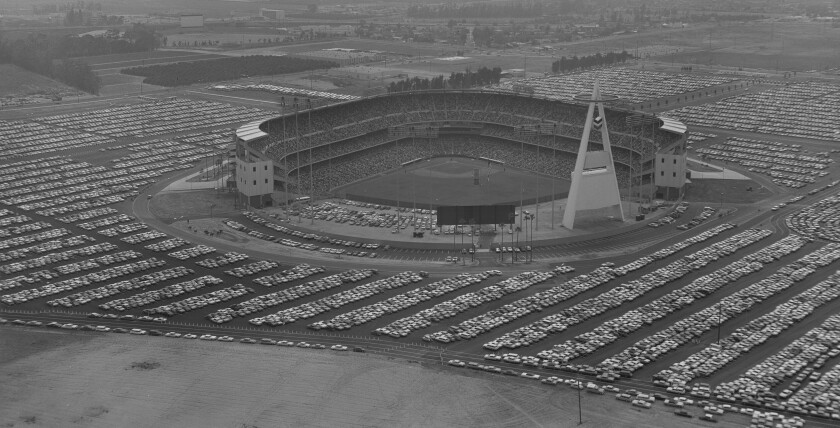 Aerial view from a distance of a baseball stadium and surrounding parking lots.