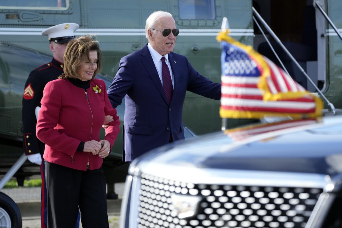 President Biden escorts Rep. Nancy Pelosi from Marine One.