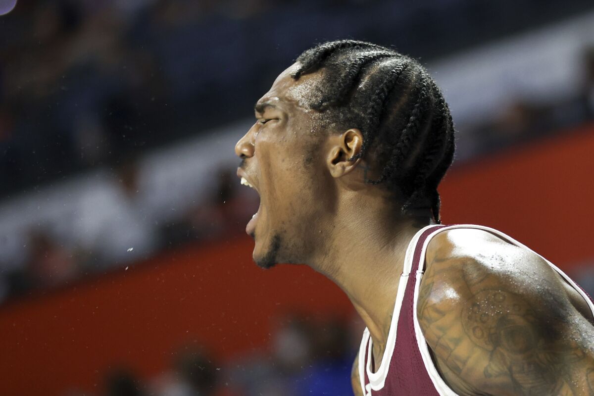 Texas Southern forward Joirdon Karl Nicholas celebrates on the bench against Florida during the second half of an NCAA college basketball game Monday, Dec. 6, 2021, in Gainesville, Fla. (AP Photo/Matt Stamey)