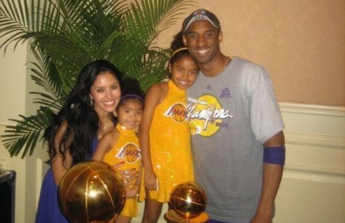 Kobe Bryant and his family posed with the Larry O'Brien Championship Trophy and MVP Award in June 2009.