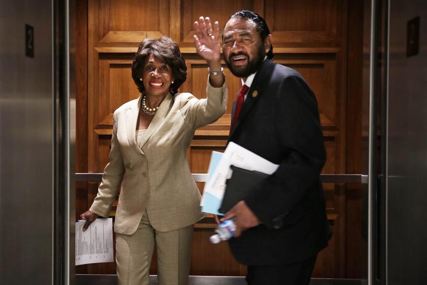 U.S. Rep. Maxine Waters, left, and Rep. Al Green take an elevator June 28, 2013, on Capitol Hill.