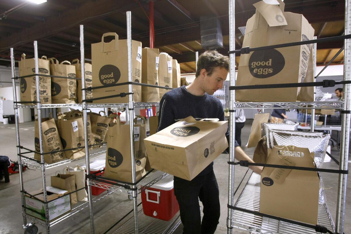 Ken Grindle fills orders on Wednesday, Feb. 19, 2014 at Good Eggs L.A., an online organic food market that recently opened a distribution center at the site of the former Hostess bakery on the 2700 block of Clearwater St., in L.A. The distribution center packs and sends out produce and goods from local farmers and producers from throughout the L.A. area, delivered by Good Eggs drivers.