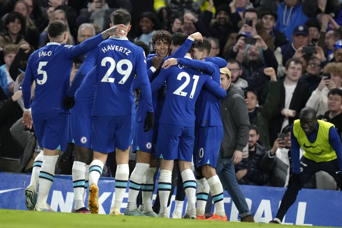 Chelsea players celebrate after Chelsea's Joao Felix, centre, scored his side's opening goal during the English Premier League soccer match between Chelsea and Everton at Stamford Bridge stadium in London, Saturday, March 18, 2023. (AP Photo/Kirsty Wigglesworth)