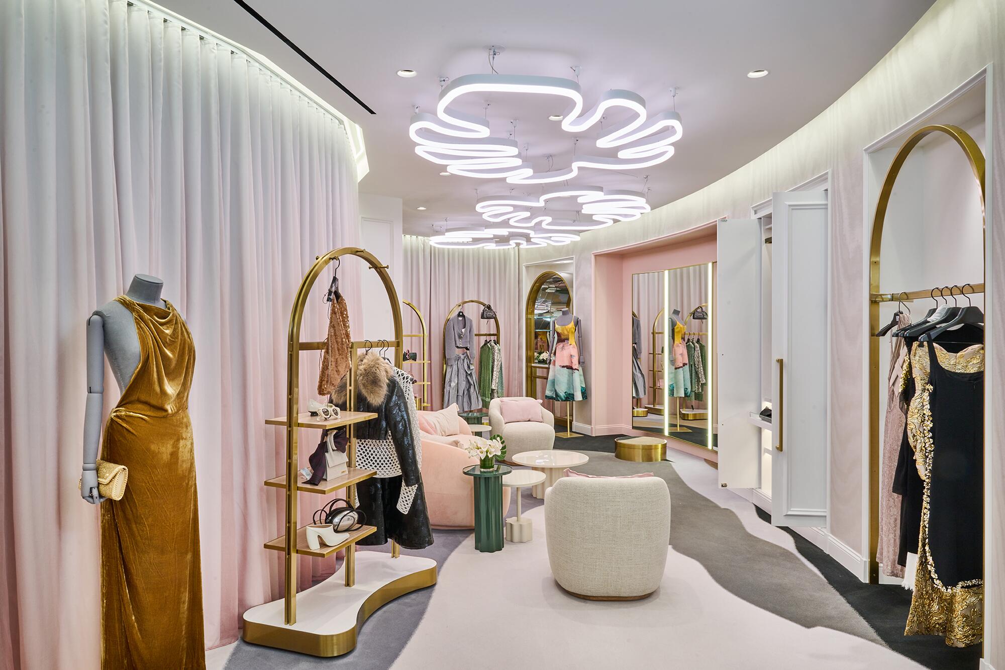 Inside a space featuring mannequins, chairs and more at Saks Fifth Avenue.