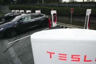 FILE - A Tesla vehicles charge, Wednesday, Sept. 27, 2023, in Woodstock, Ga. Tesla reports their earnings on Wednesday, Jan. 24, 2024. (AP Photo/Mike Stewart, File)