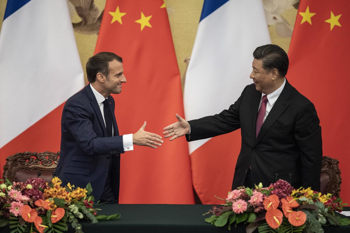 French President Emmanuel Macron, left, shakes hands with Chinese President Xi Jinping following a signing ceremony at the Great Hall of the People in Beijing, Wednesday, Nov. 6, 2019.