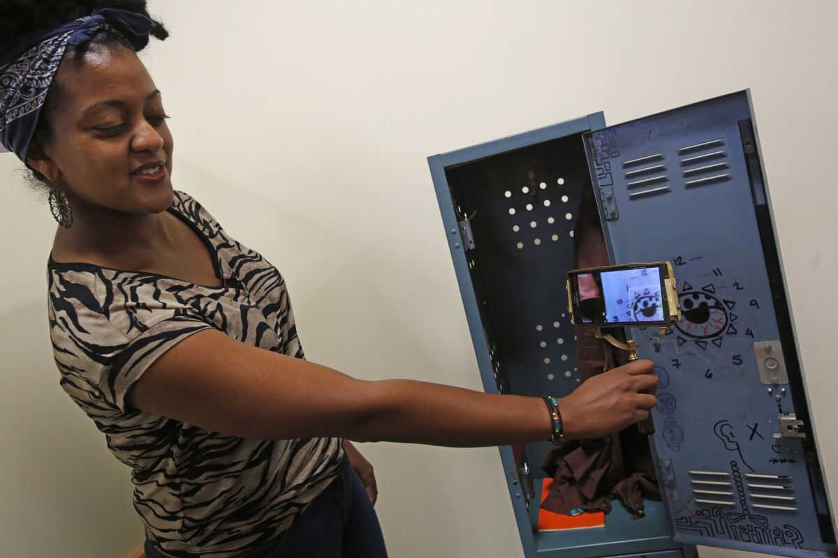 Lishan Amde explains her game titled "The Locker." To play, the gamer looks for clues to solve a murder -- all in a locker room.