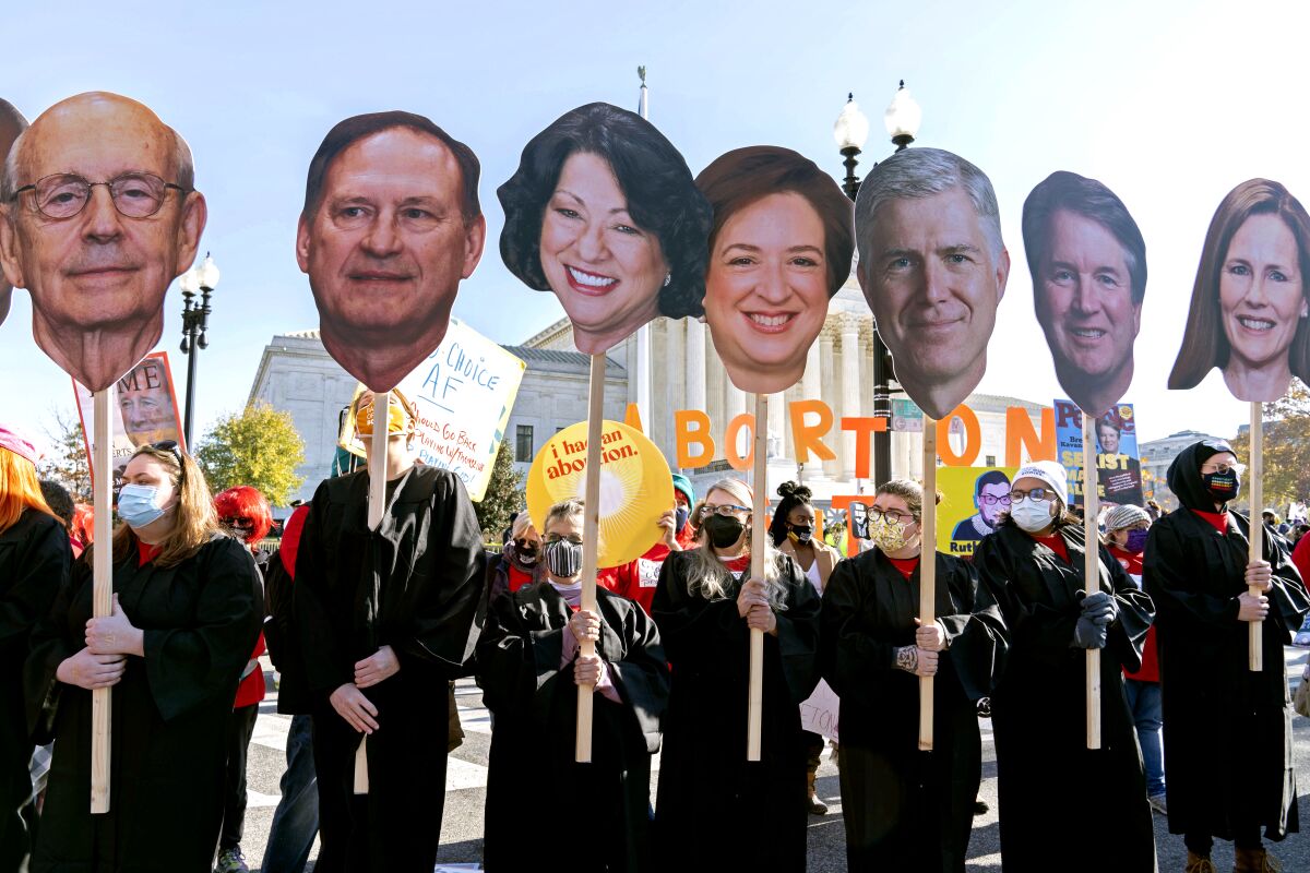 Abortion rights advocates holding cardboard cutouts of the justices outside the U.S. Supreme Court on Wednesday.