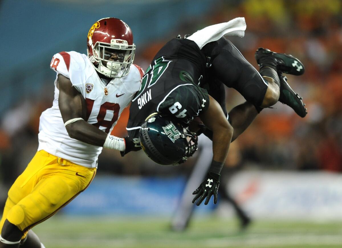 Hawaii's Donnie King Jr. is upended in front of USC safety Dion Bailey during the Trojans' win on Thursday. Bailey likely will see plenty of action Saturday against pass-happy Washington State.