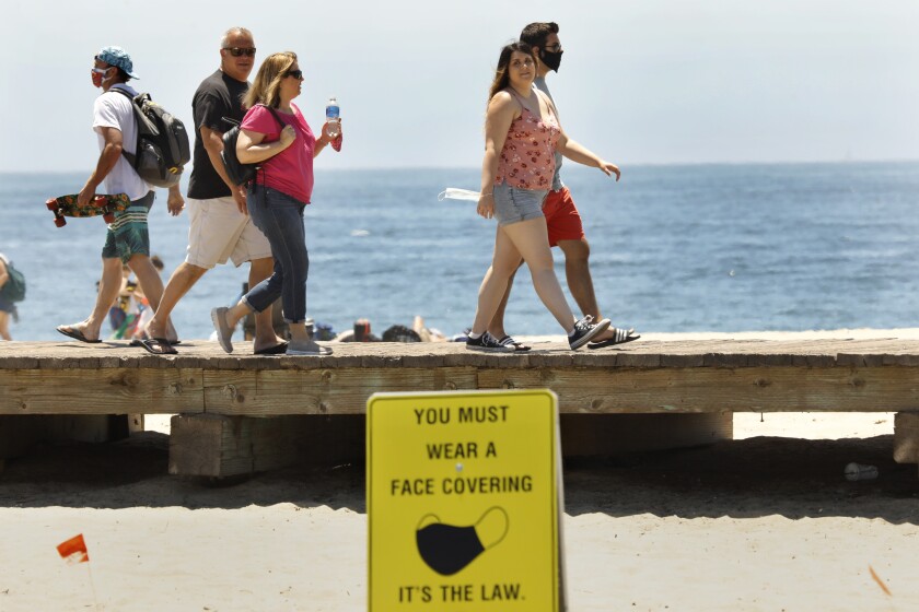Many Orange County beachgoers are choosing not to wear masks despite the pleas of medical experts.