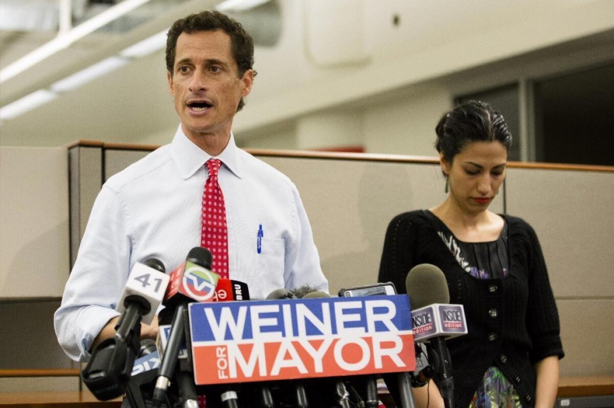New York mayoral candidate Anthony Weiner speaks during a news conference alongside his wife Huma Abedin on Tuesday. The former congressman says he's not dropping out of the race in light of newly revealed explicit online correspondence.
