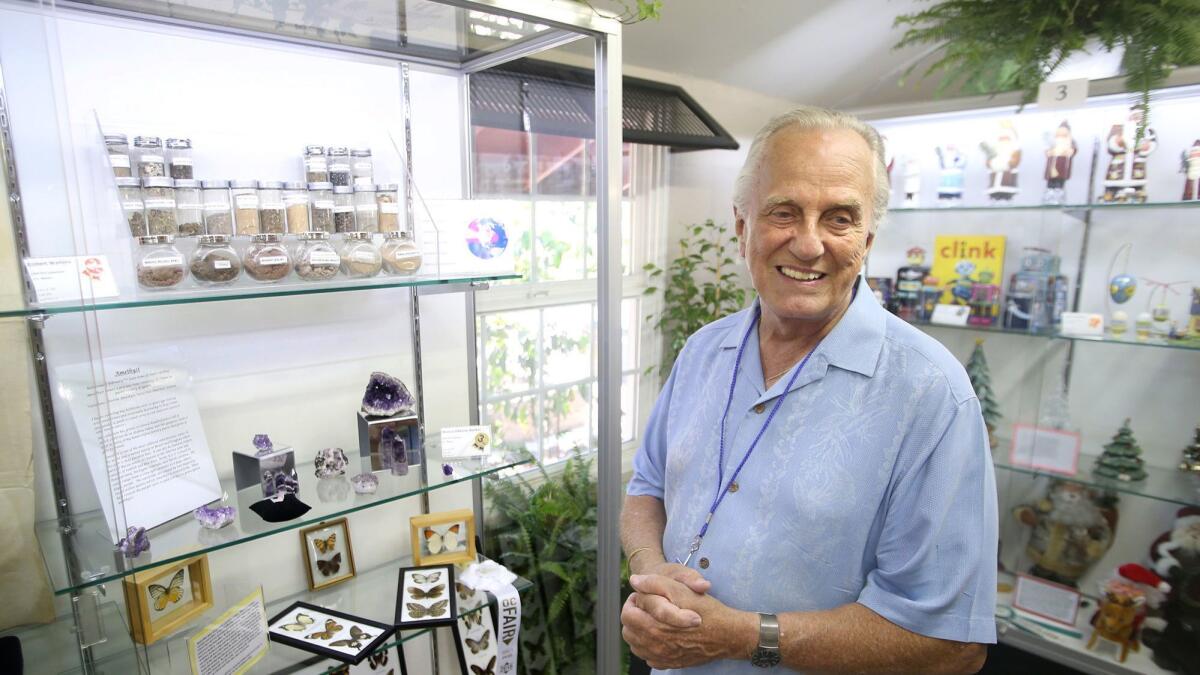 Bob Walters shows dirt samples he has collected from famous spots around the world and is displaying at the Orange County Fair. He started collecting what he calls “the ultimate souvenir” in 1959.